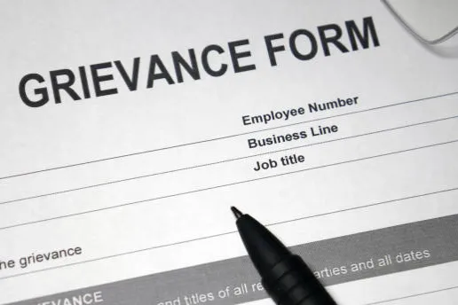 Photo of a sheet of paper titled Grievance Form.