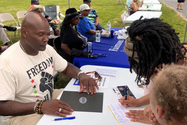 Retiree Herbert Hughey signs up voters.