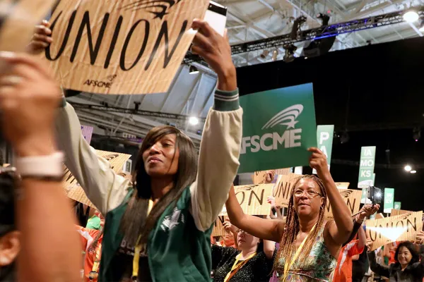 A woman holding a sign saying "union".