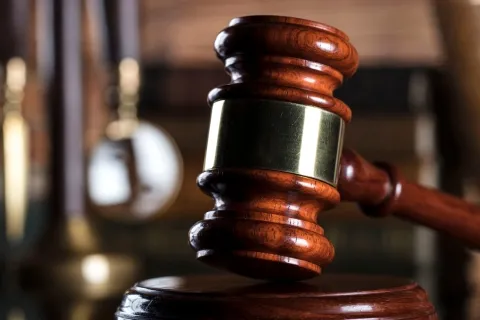 Stock image of a gavel in a courtroom.