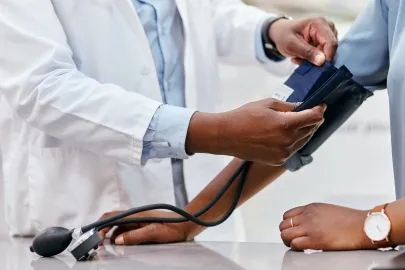 A doctor takes someone's blood pressure