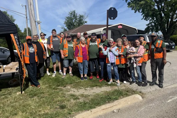 School bus drivers and monitors pose after having their union certified.