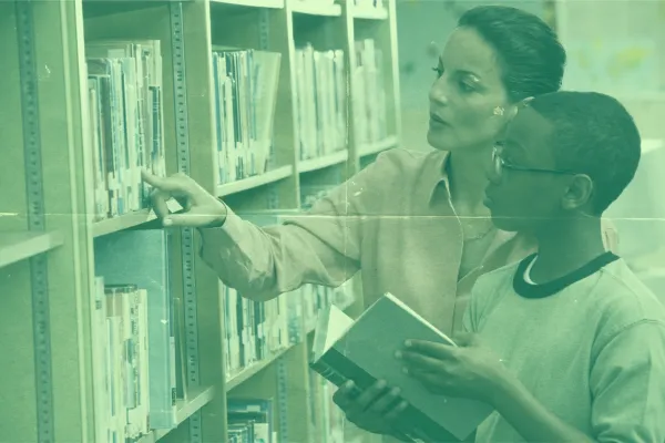 A stock image of a librarian in a row of books.