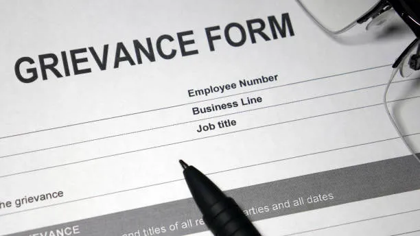 Photo of a sheet of paper titled Grievance Form.