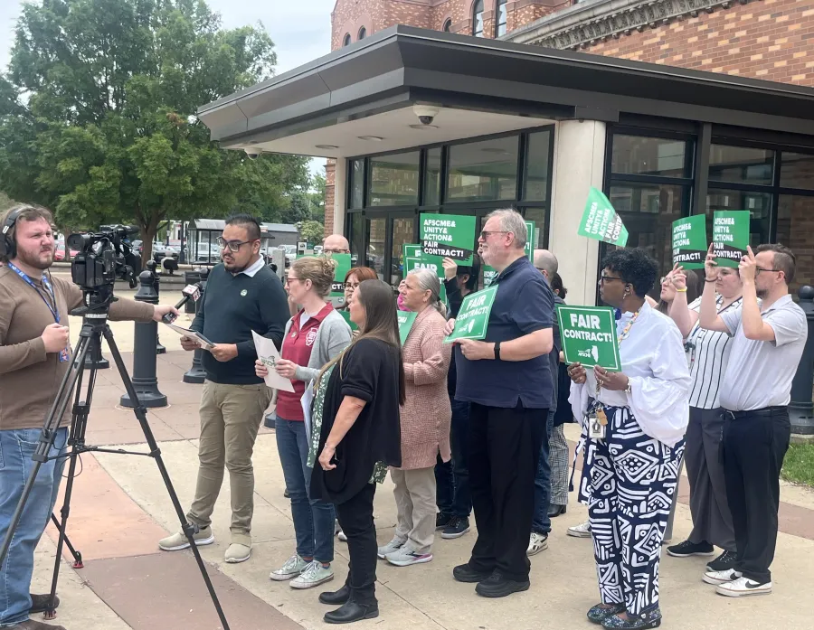 Champaign County employees announce the results of their strike vote in May 2025.