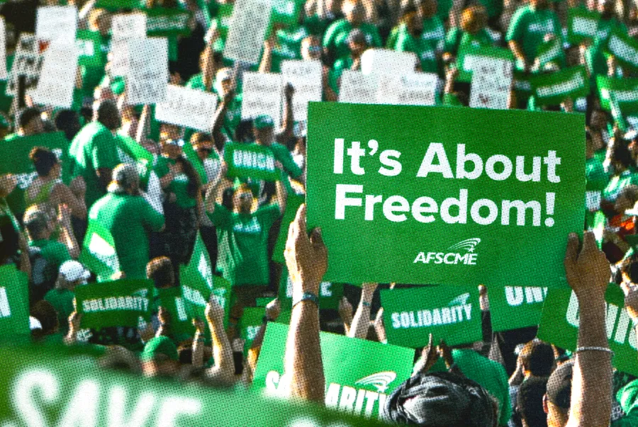 AFSCME member holding sign that says "It's about freedom"