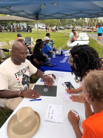Retiree Herbert Hughey signs up voters.