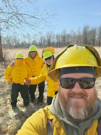 Members of AFSCME Local 1019 at Sangchris Lake State Park in their firefighting gear, performing a prescribed burn.